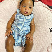 Yasmin is registered to the contest to win money with this photo: baby, baseballcap, bed, cap, clothing, couch, cushion, face, furniture, hat, head, homedecor, indoors, newborn, pants, person, photography, portrait, shorts, sitting