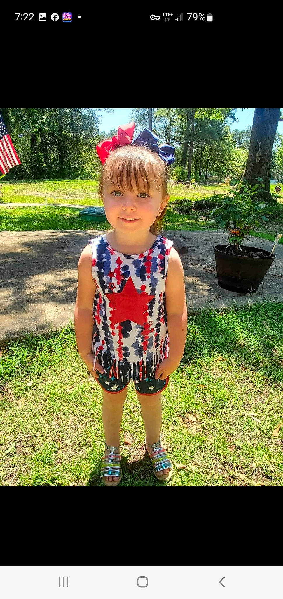 Ireland is registered to the contest to win money with this photo: baby_toddler_clothing, dress, electric_blue, flag, flag_of_the_united_states, flowerpot, grass, hair, happy, head, houseplant, joy, leaf, leisure, people_in_nature, person, plant, recreation, smile, summer