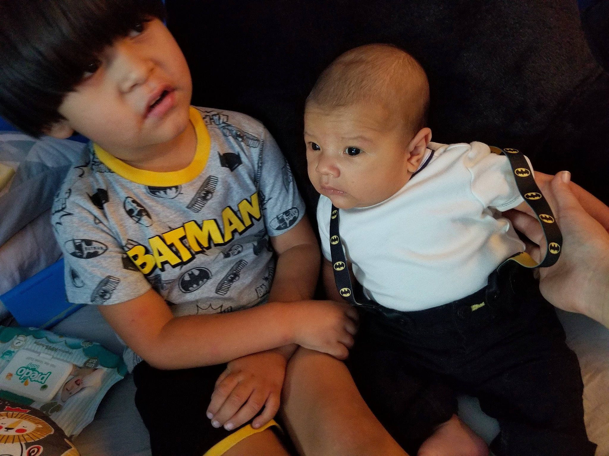 Emilio is registered to the contest to win money with this photo: arm, baby, cheek, child, cool, eye, family, finger, hand, happy, human, interaction, iris, lap, people, person, sitting, skin, smile, t_shirt