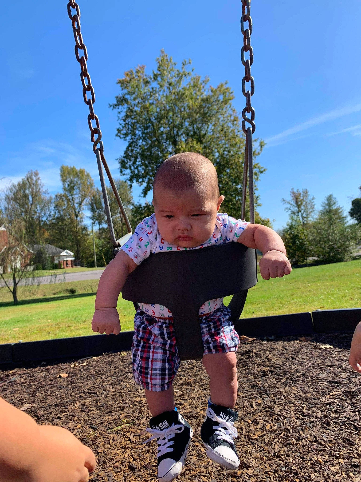 Arlo James joined the competition — help win amazing prizes! child, city, design, fun, outdoor_play_equipment, pattern, person, play, playground, public_space, recreation, swing, tartan, toddler, tree