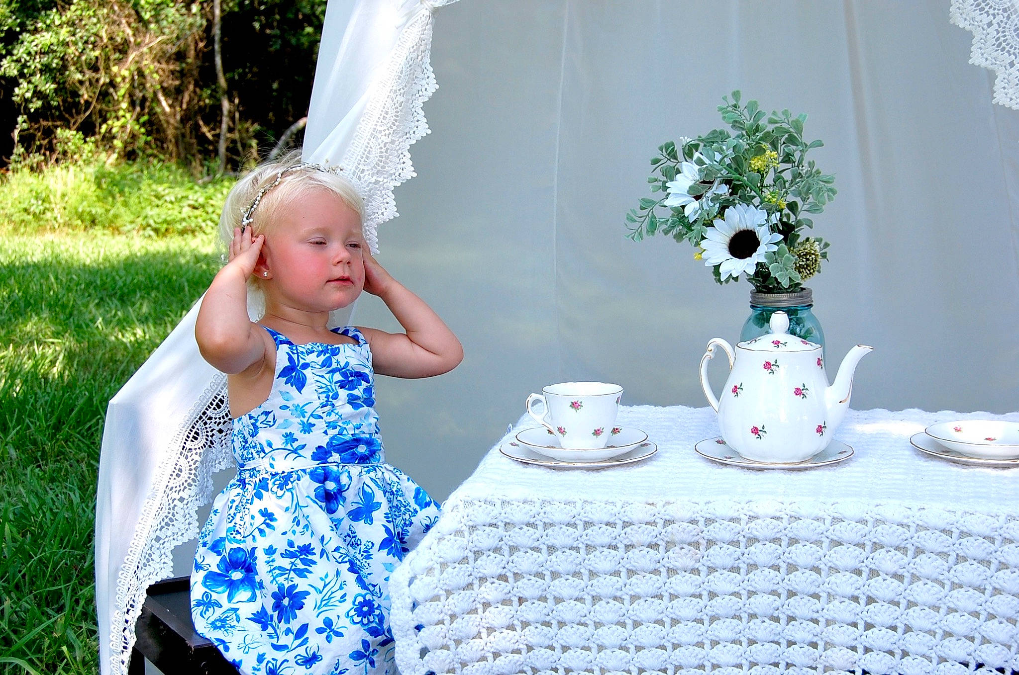 Addisyn is registered to the contest to win money with this photo: chair, coffee_cup, cup, dishware, dress, drinkware, grass, green, happy, person, plant, porcelain, serveware, table, tablecloth, tableware, teacup, textile, toddler, tree
