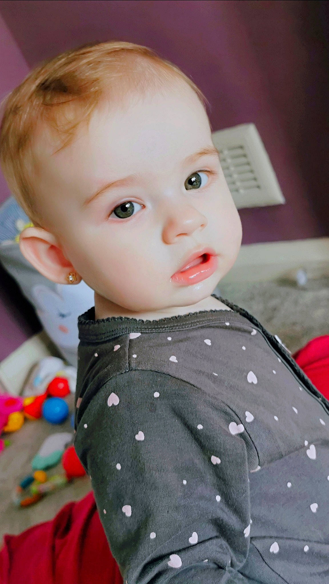 Mara is registered to the contest to win money with this photo: baby, brown_hair, cheek, child, chin, design, eye, face, forehead, head, iris, lip, nose, outerwear, pattern, person, polka_dot, skin, toddler