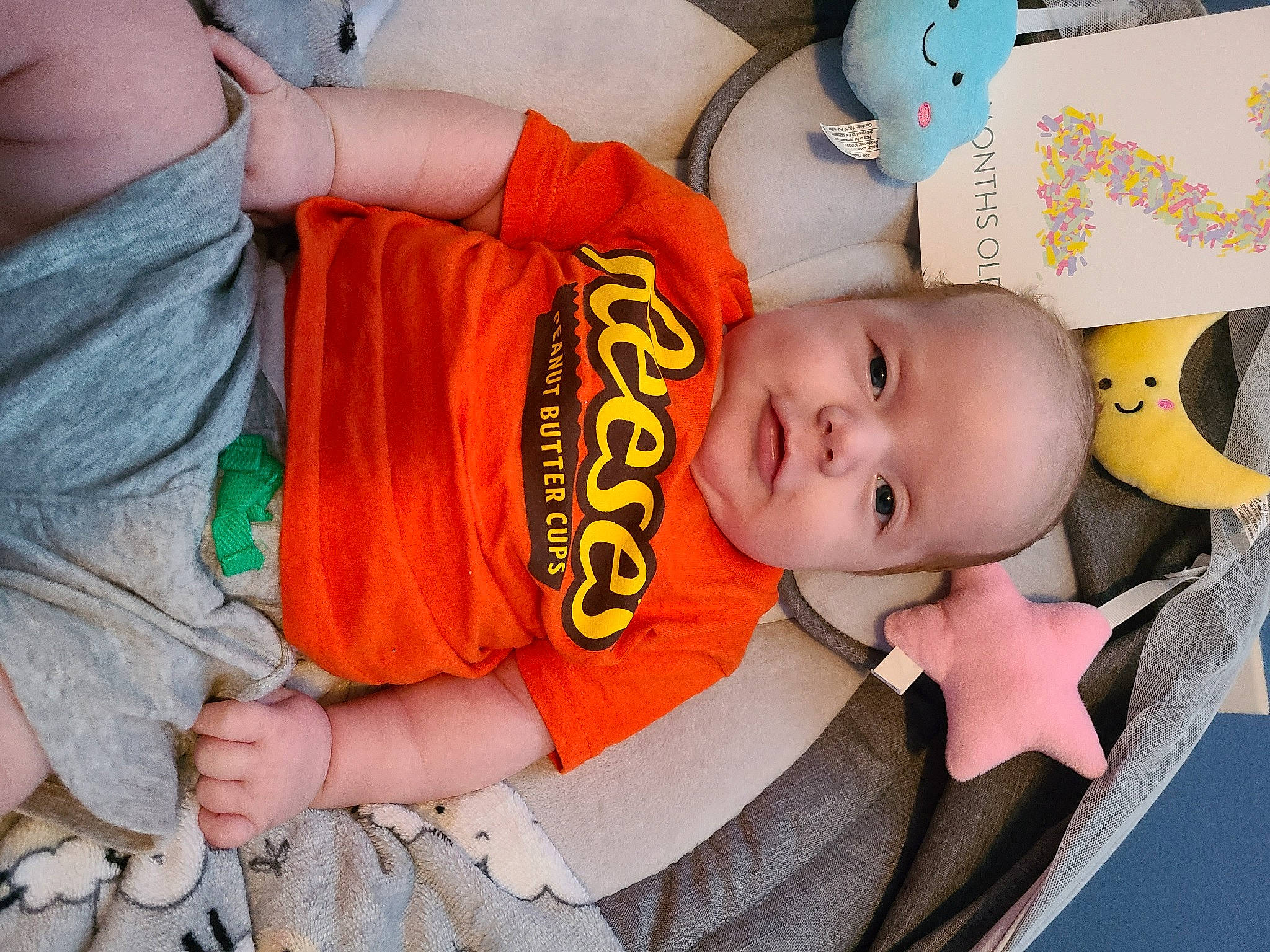 Dominick joined the competition — help win amazing prizes! arm, baby, baby_carriage, baby_products, baby_toddler_clothing, cheek, child, comfort, finger, fun, happy, human, human_body, mouth, orange, person, product, sleeve, t_shirt, textile