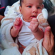 Nihaal is registered to the contest to win money with this photo: baby, blanket, infant, hands, face, person, newborn, clothing, soft, cute, curious, wrapped, human, skin, portrait, indoors, fingers, holding, warm, toddler