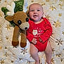 Bentley is registered to the contest to win money with this photo: baby, infant, red_clothing, crocheted_toy, reindeer, blanket, snowflake_pattern, holiday_theme, christmas, smiling, soft_texture, cute, lying_down, festive, child, indoors, happy, plush_toy, winter, cozy