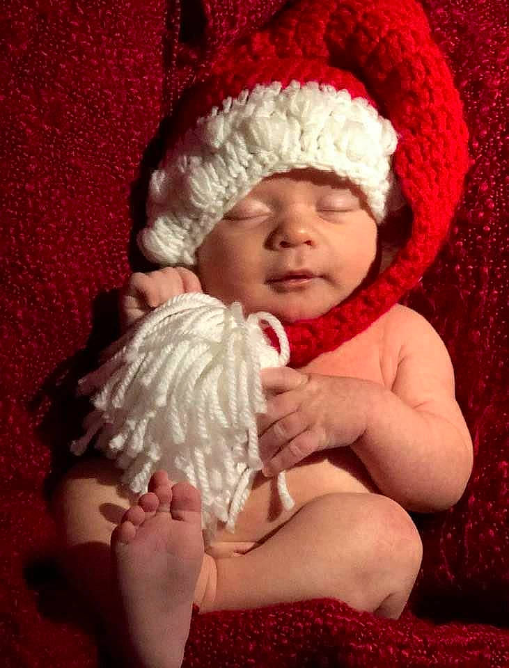 Colton joined the competition — help win amazing prizes! baby, beanie, bonnet, cheek, child, fictional_character, fur, hand, hat, headgear, headwear, human_body, knit_cap, person, red, smile, toddler, wool