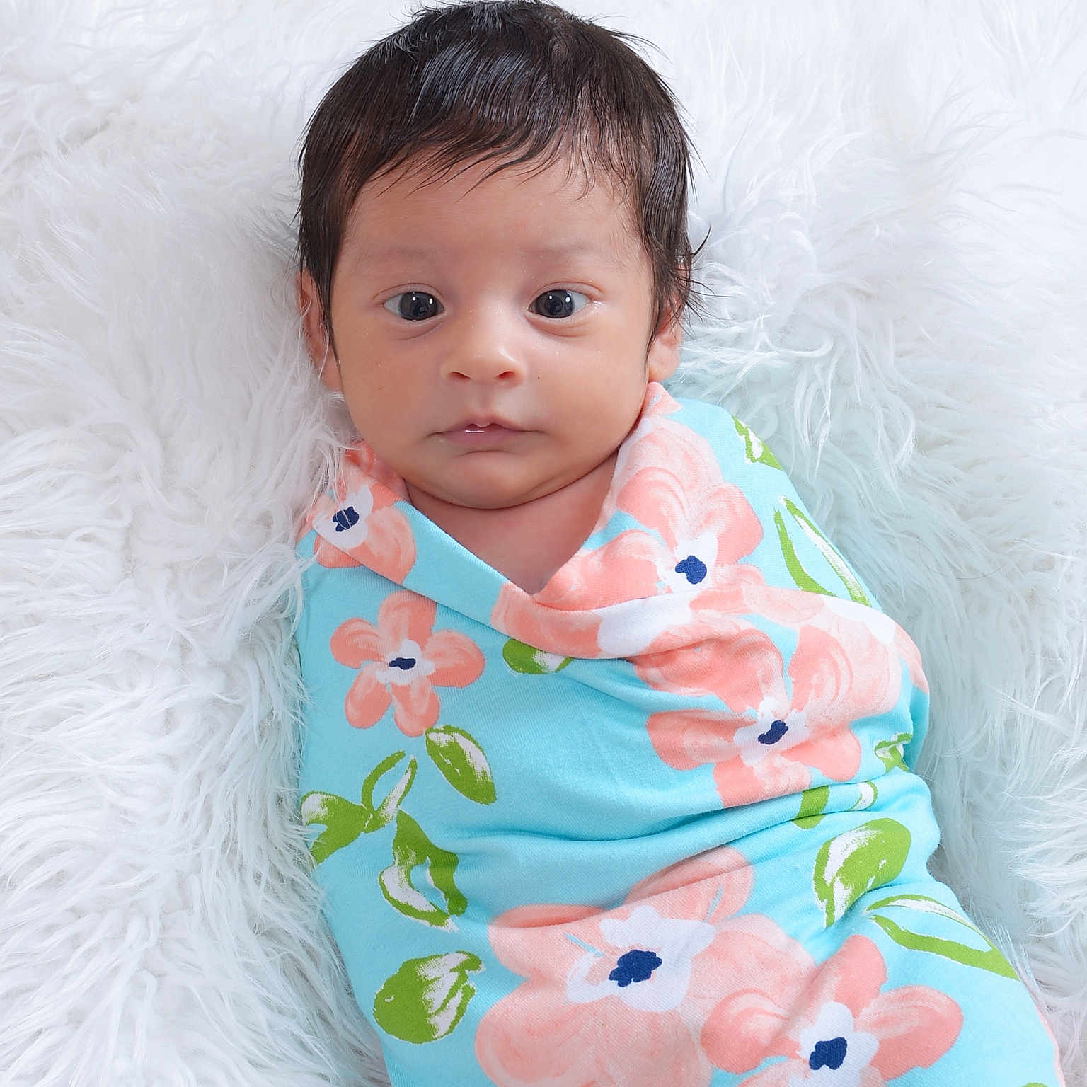Azyna is registered to the contest to win money with this photo: baby, blanket, blue, calm, child, cozy, cute, face, floral_pattern, green, indoors, infant, looking_at_camera, newborn, pink, portrait, soft_texture, white_background, wrapped, young_child