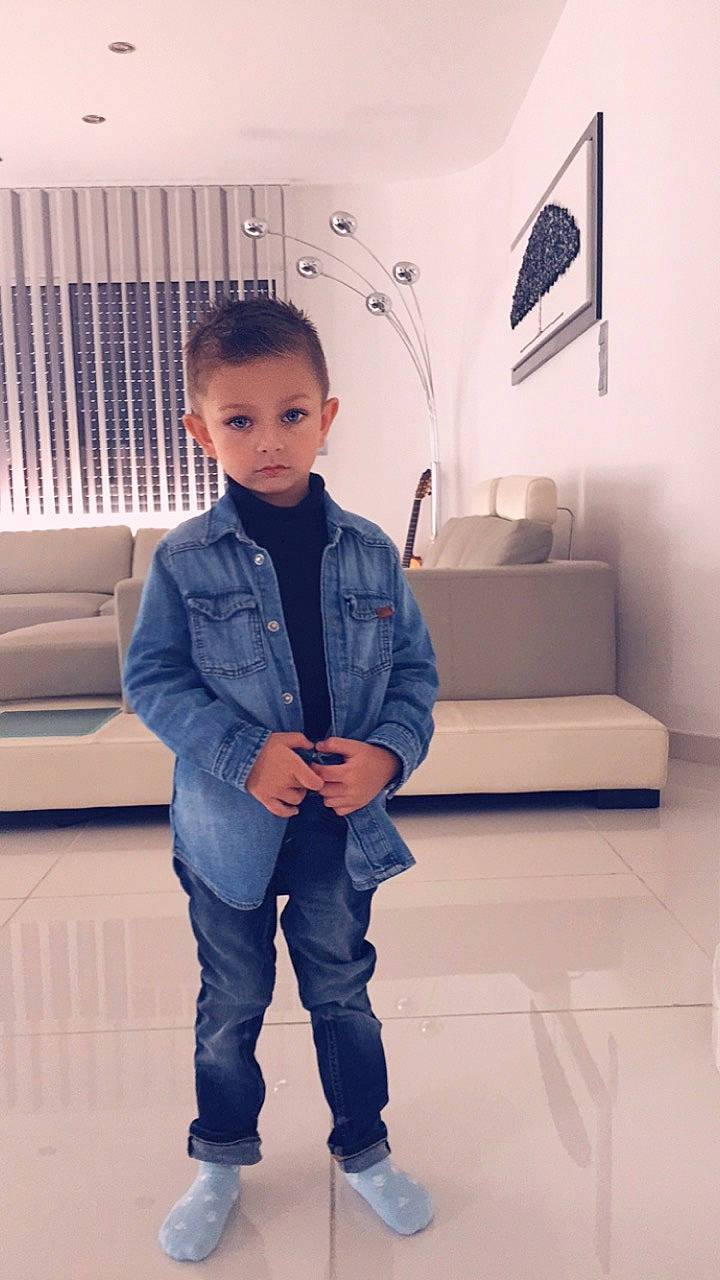 Kylian a rejoint le concours — aidez-le/la à gagner de superbes lots ! child, collar, denim, dress_shirt, electric_blue, fashion_design, flooring, formal_wear, hairstyle, knee, person, picture_frame, product, shoulder, sitting, skin, sleeve, standing, toddler, waist