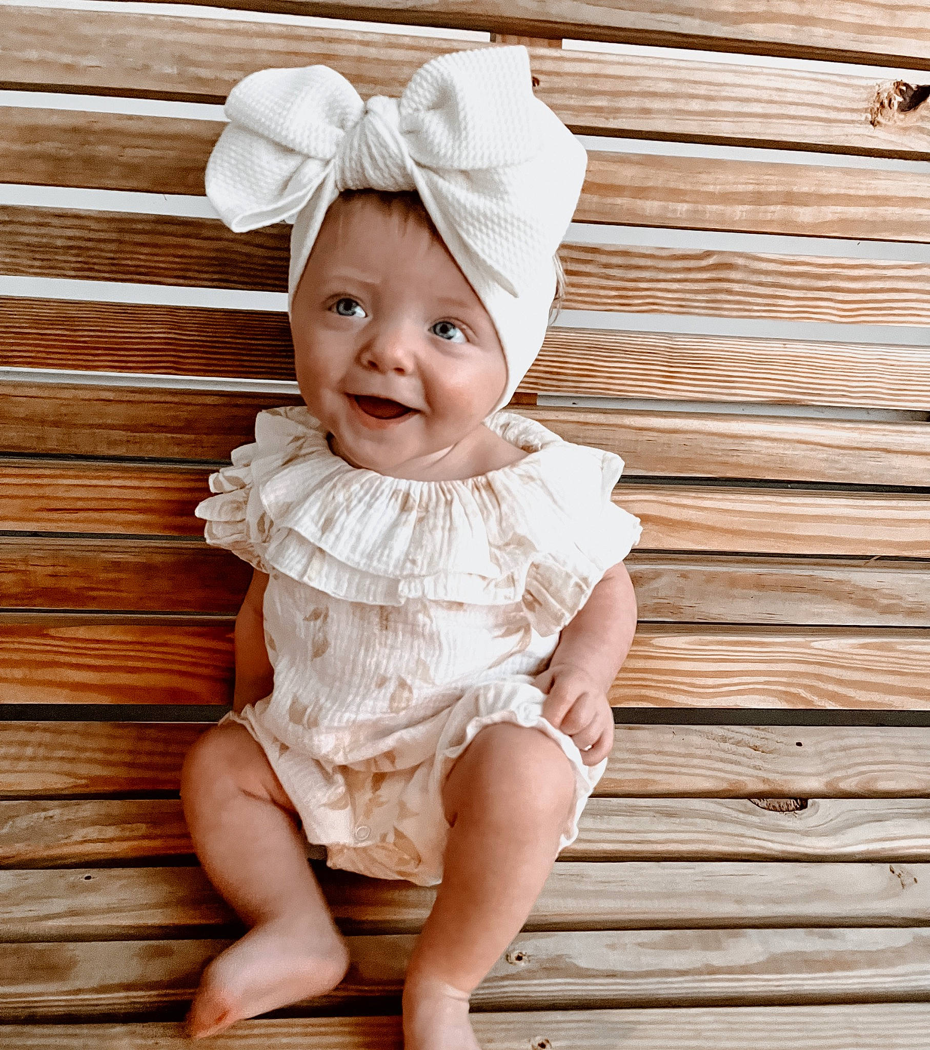 Oakleigh is registered to the contest to win money with this photo: baby, baby_toddler_clothing, child, eye, fashion_accessory, flash_photography, grass, happy, headband, headpiece, headwear, iris, joy, lip, pattern, person, pink, skin, sleeve, smile