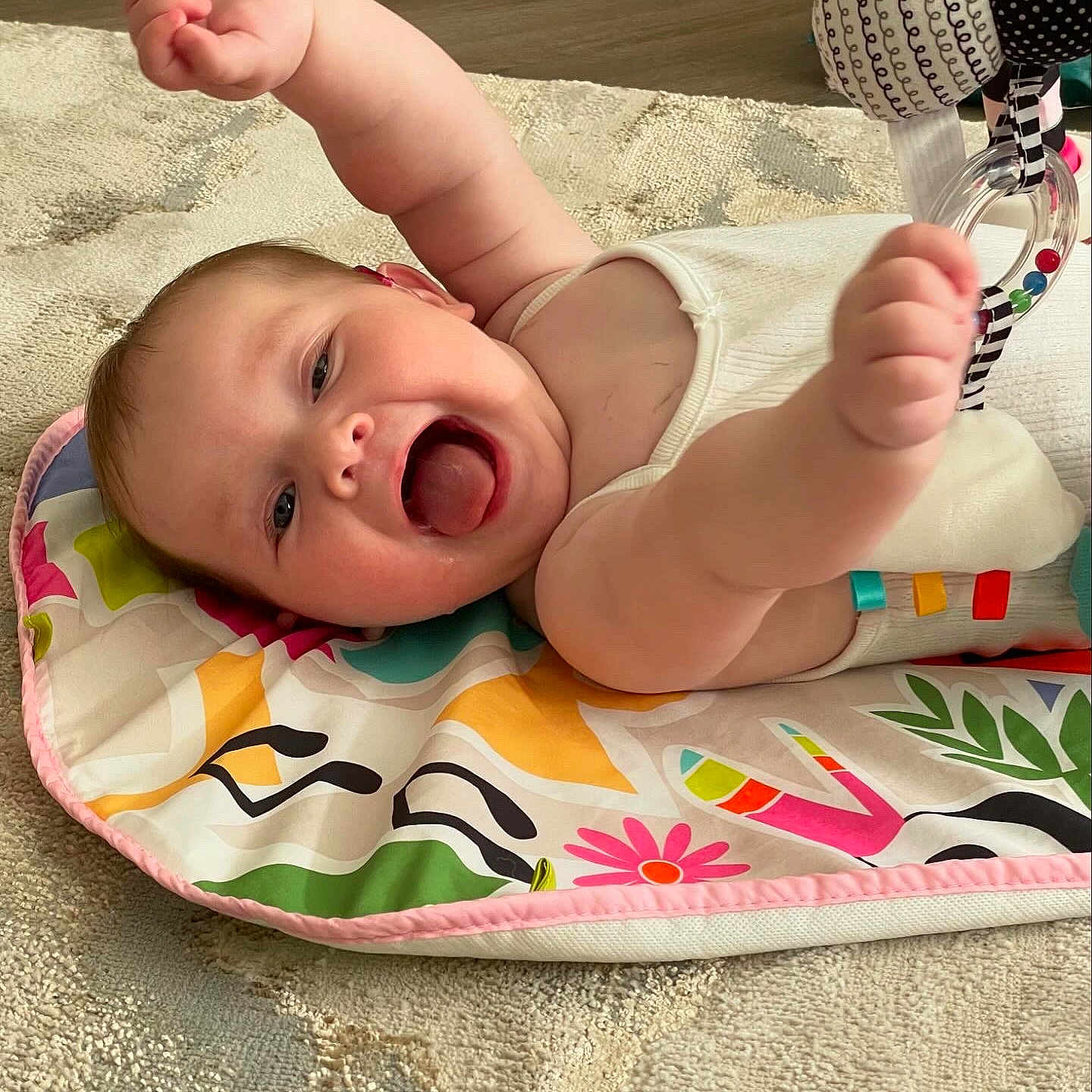 Florence is registered to the contest to win money with this photo: baby, babylaughing, face, happy, head, person, photography, pingpong, pingpongpaddle, portrait, quilt, racket, sport, tape, yawning