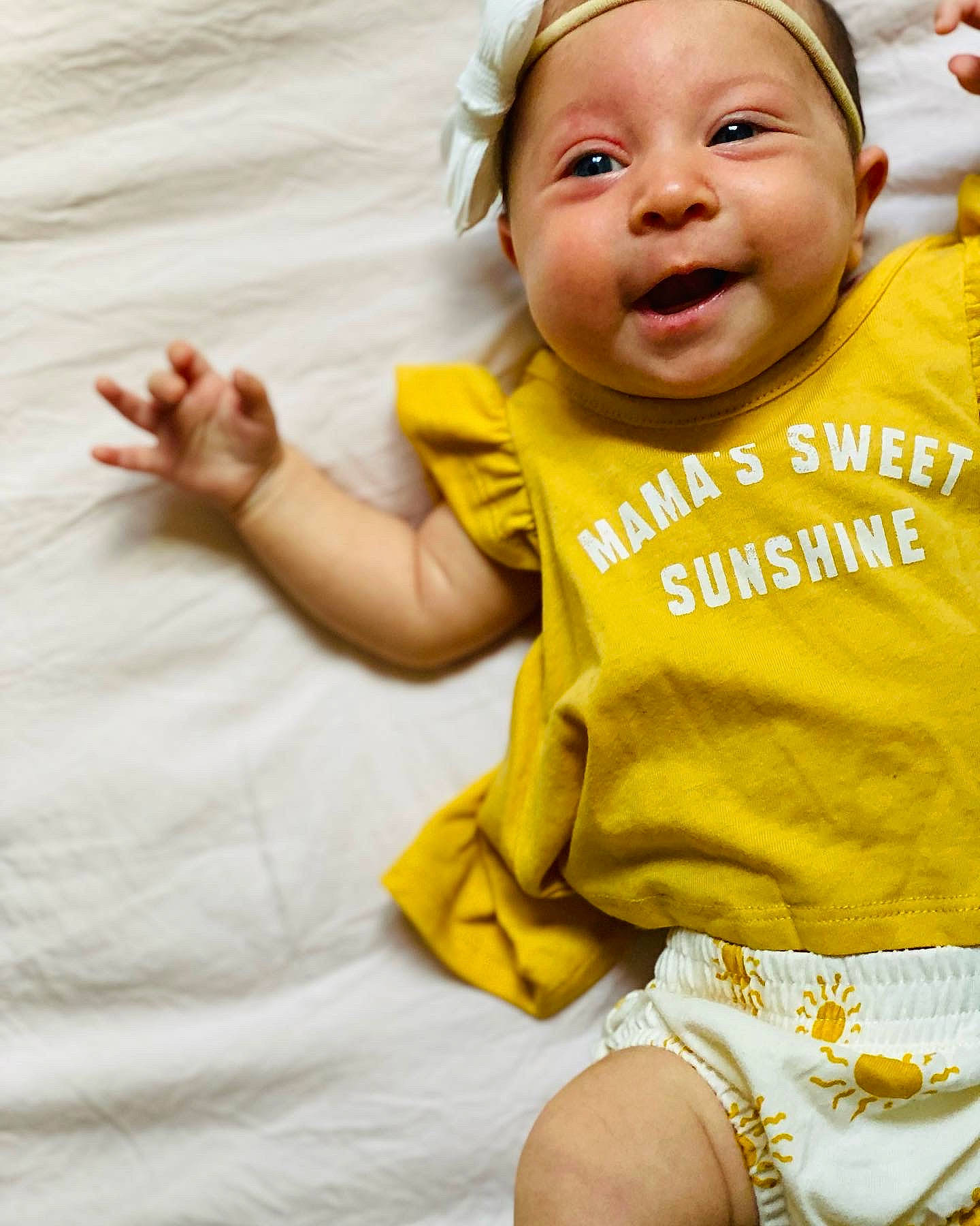 Selah is registered to the contest to win money with this photo: arm, baby_toddler_clothing, cheek, chin, comfort, eye, eyebrow, finger, gesture, hairstyle, hand, happy, head, lip, mouth, nose, person, skin, sleeve, smile