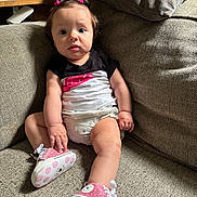 Aviana joined the competition — help win amazing prizes! baby, child, infant, girl, pink, hair_clips, sneakers, shoes, polka_dots, couch, sofa, seated, clothing, black_shirt, white_shorts, indoor, furniture, curious, expression, portrait