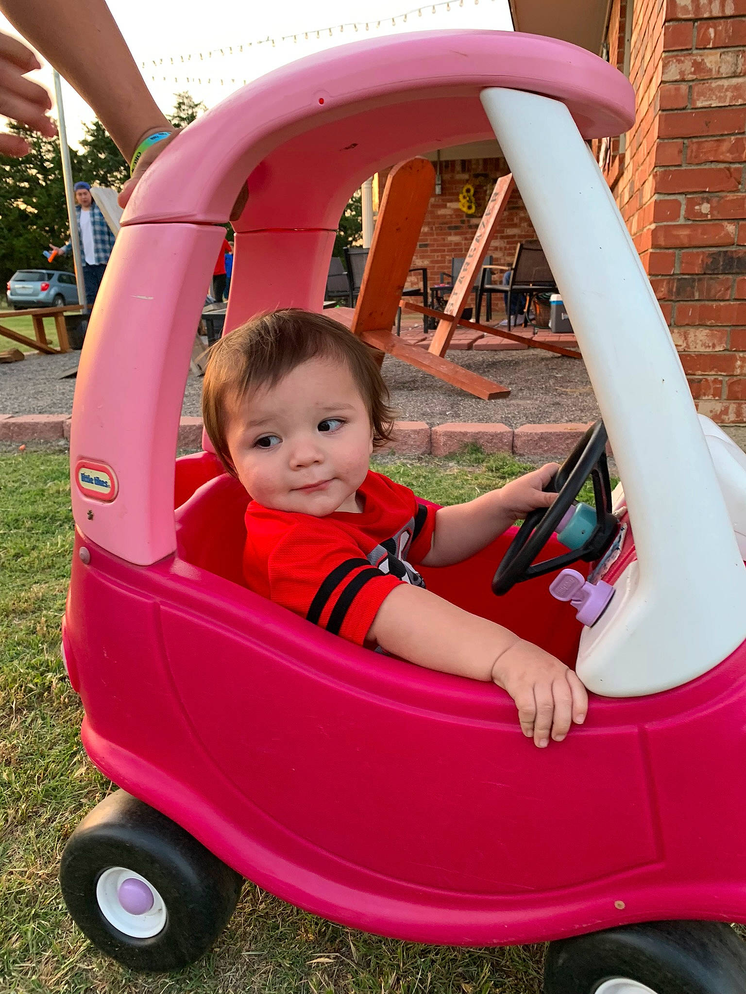 Forrest is registered to the contest to win money with this photo: automotive_wheel_system, baby_products, beauty, child, fun, grass, green, magenta, motor_vehicle, person, photograph, pink, plant, product, red, snapshot, tire, toddler, vehicle, wheel