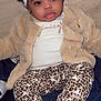 baby, child, headband, bow, jacket, leopard_print, pants, socks, white_socks, cute, infant, fashion, portrait, smiling, indoor, floor, blanket, clothing, face, person