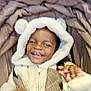 child, smiling, hood, coat, jacket, blanket, brown, cream, fur, happy, cute, outdoor, warm_clothing, baby, portrait, person, young, cozy, fun, playful