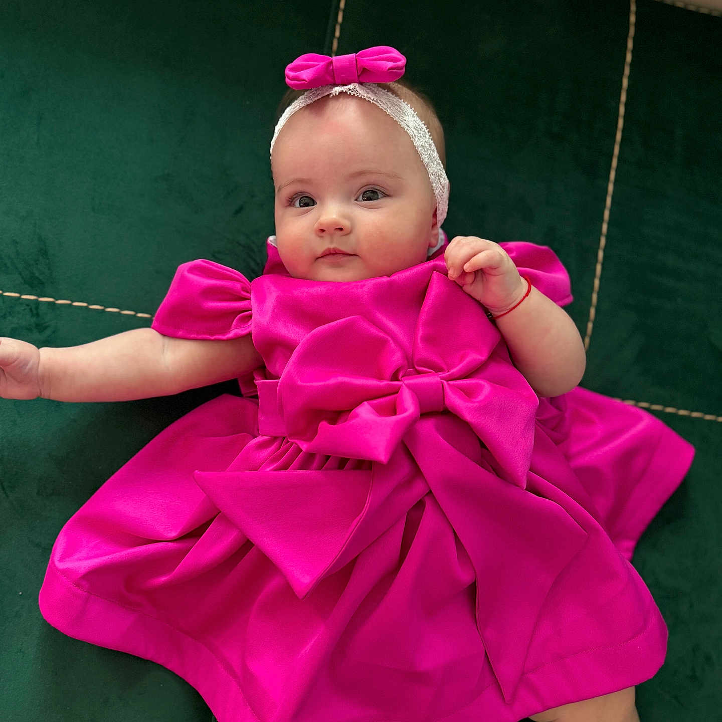 Evelinne joined the competition — help win amazing prizes! adorable, baby, baby_clothing, baby_face, bow, child, child_fashion, cushion, cute, green_cushion, headband, indoor, infant, looking_at_camera, lying_down, pink_dress, portrait, relaxed, small_hand, soft_fabric