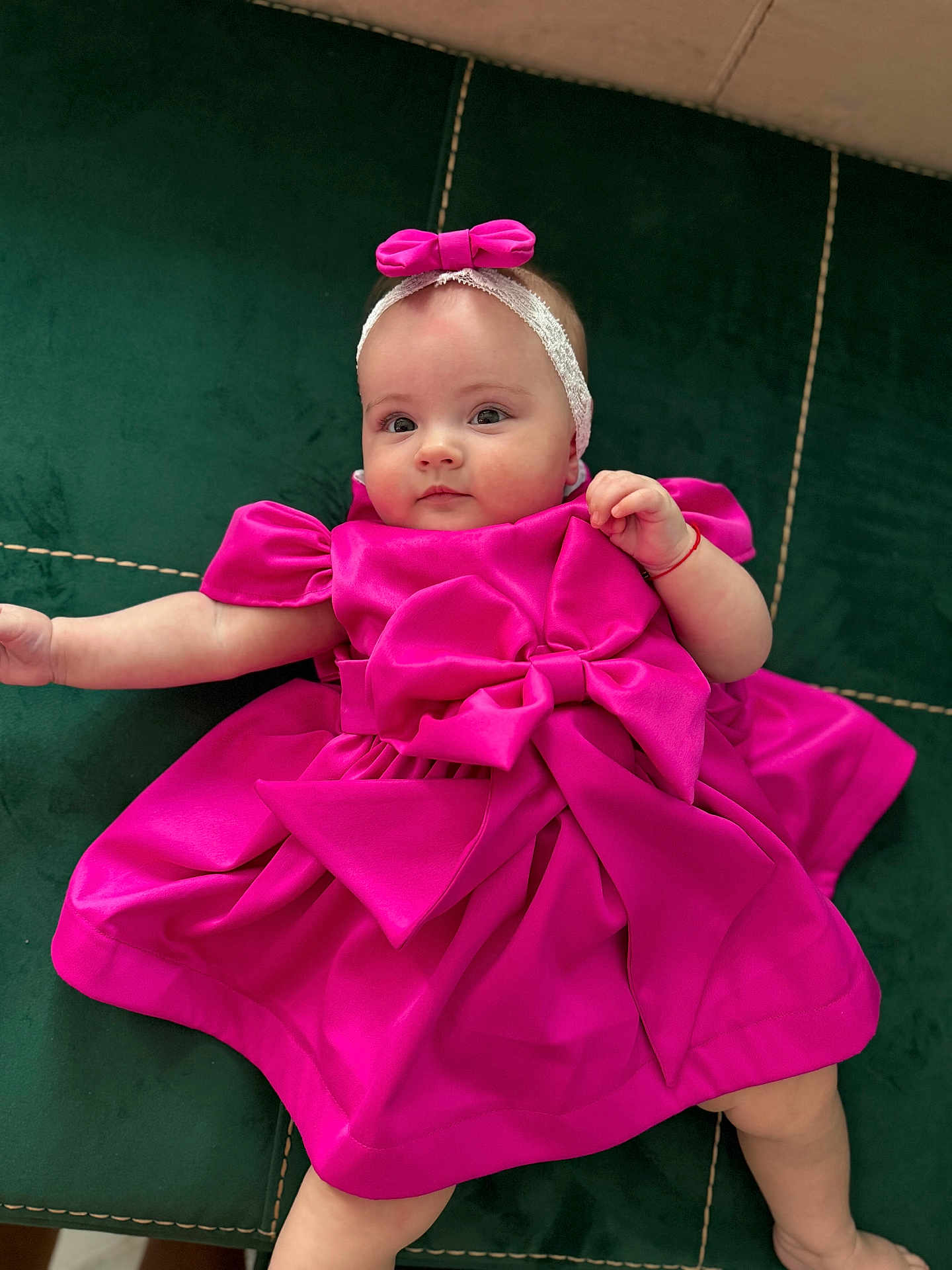 Evelinne joined the competition — help win amazing prizes! baby, child, pink_dress, headband, bow, cushion, green_cushion, infant, portrait, cute, lying_down, indoor, soft_fabric, small_hand, baby_face, baby_clothing, relaxed, looking_at_camera, child_fashion, adorable