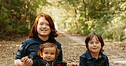 Theodore joined the competition — help win amazing prizes! children, siblings, baby, toddler, portrait, smiling, outdoor, forest, woodland, nature, family, sitting, path, trees, sunlight, leaves, casual_clothing, black_shirts, blue_jeans, group_photo