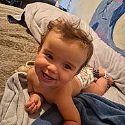 Theodore joined the competition — help win amazing prizes! baby, smiling, toddler, bed, blanket, diaper, indoor, face, child, happy, hair, skin, furniture, painting, room, cozy, cushion, person, expression, relaxing