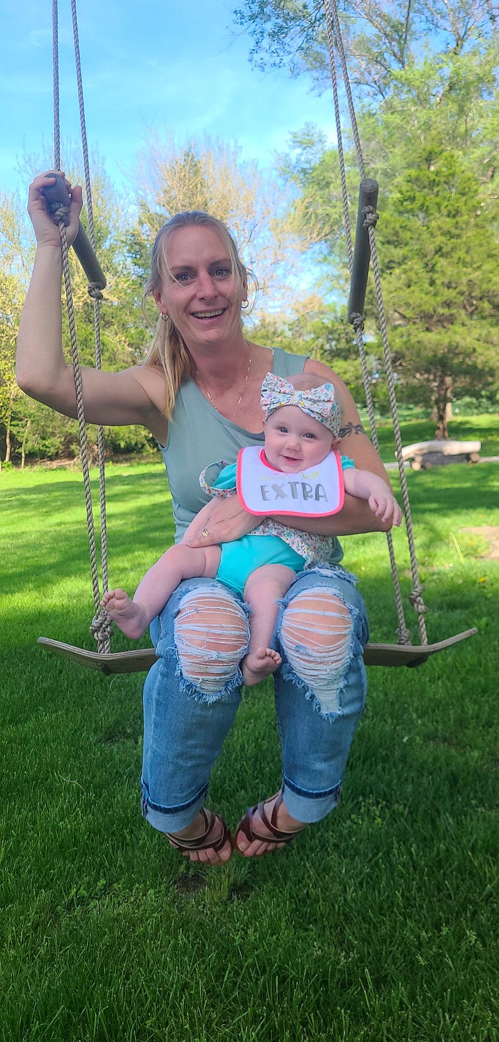 Iris is registered to the contest to win money with this photo: baby, baby_toddler_clothing, child, event, fun, grass, grass_family, happy, headwear, jeans, joy, lap, leisure, person, pink, plant, recreation, shorts, sky, smile