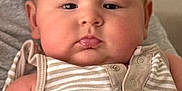 Sam joined the competition — help win amazing prizes! adult_hand, arm, baby, background, casual, child, chubby_cheeks, cute, face, holding, indoor, infant, neutral_expression, onesie, person, portrait, pout, skin, striped_clothing, young_child