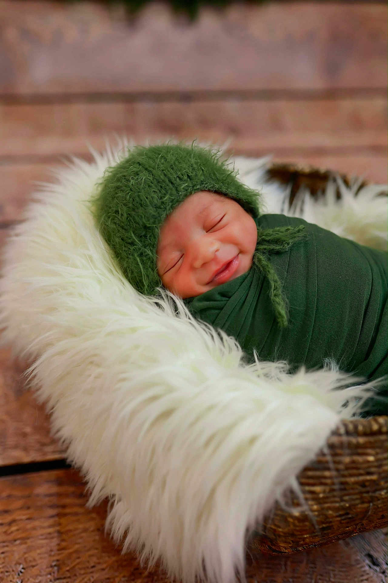Kaiisaac joined the competition — help win amazing prizes! newborn, baby, infant, swaddled, green_hat, blanket, basket, sleeping, smile, cozy, fur, wood_floor, portrait, cute, resting, soft_texture, indoors, peaceful, child, wrapped