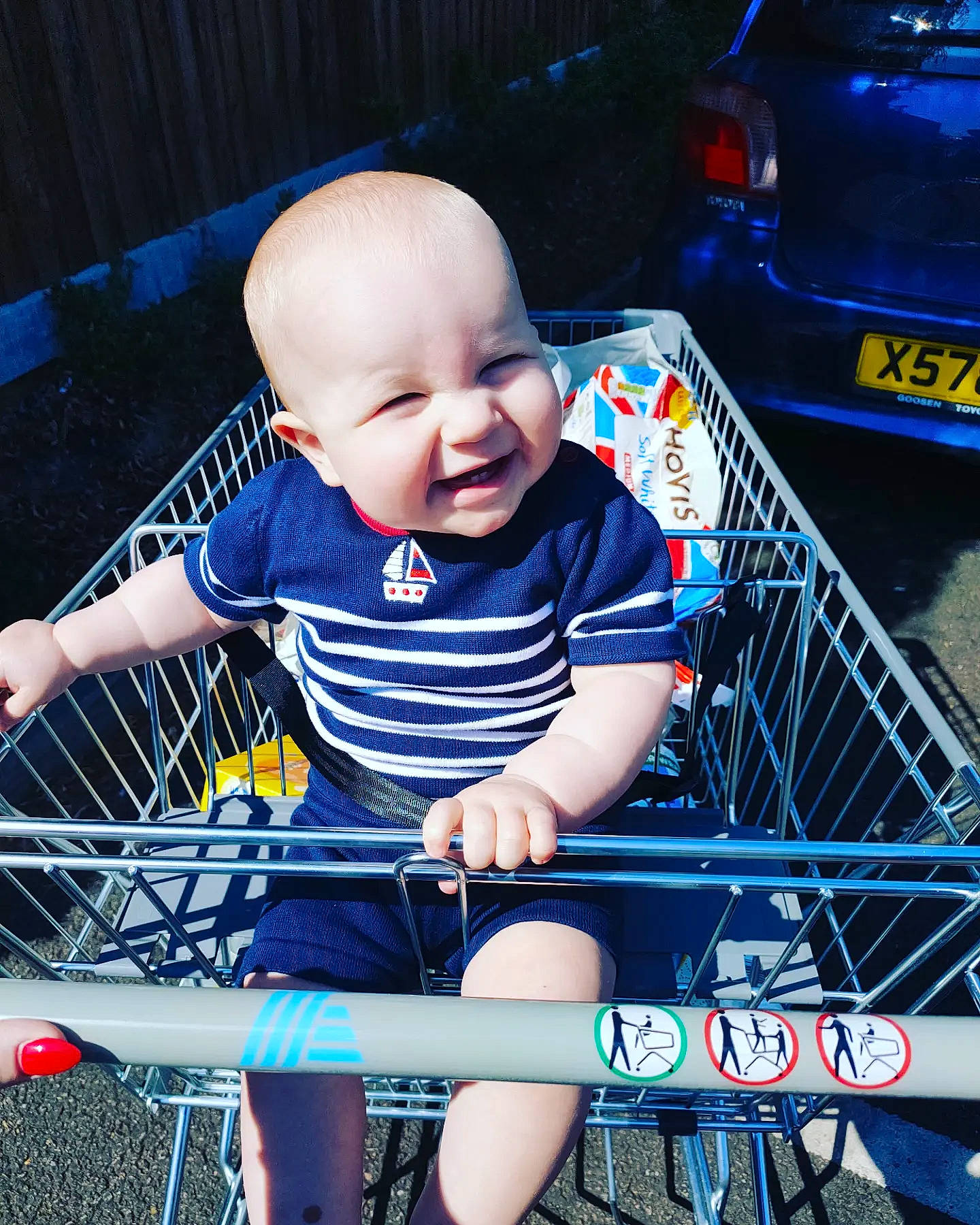 Kobe is registered to the contest to win money with this photo: automotive_design, baby, baby_carriage, baby_products, baby_toddler_clothing, chair, child, electric_blue, fun, happy, leisure, person, play, product, recreation, sitting, smile, t_shirt, toddler, vehicle