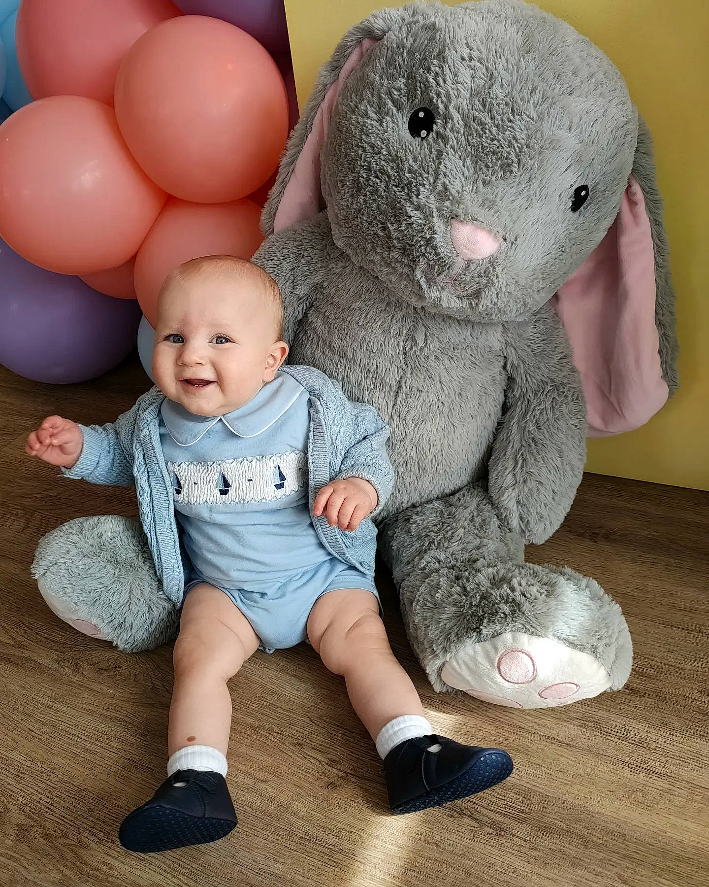 Kobe is registered to the contest to win money with this photo: baby, baby_products, baby_toddler_clothing, balloon, child, comfort, elephant, foot, grey, happy, head, mammal, person, pink, sitting, skin, smile, teddy_bear, toddler, toy