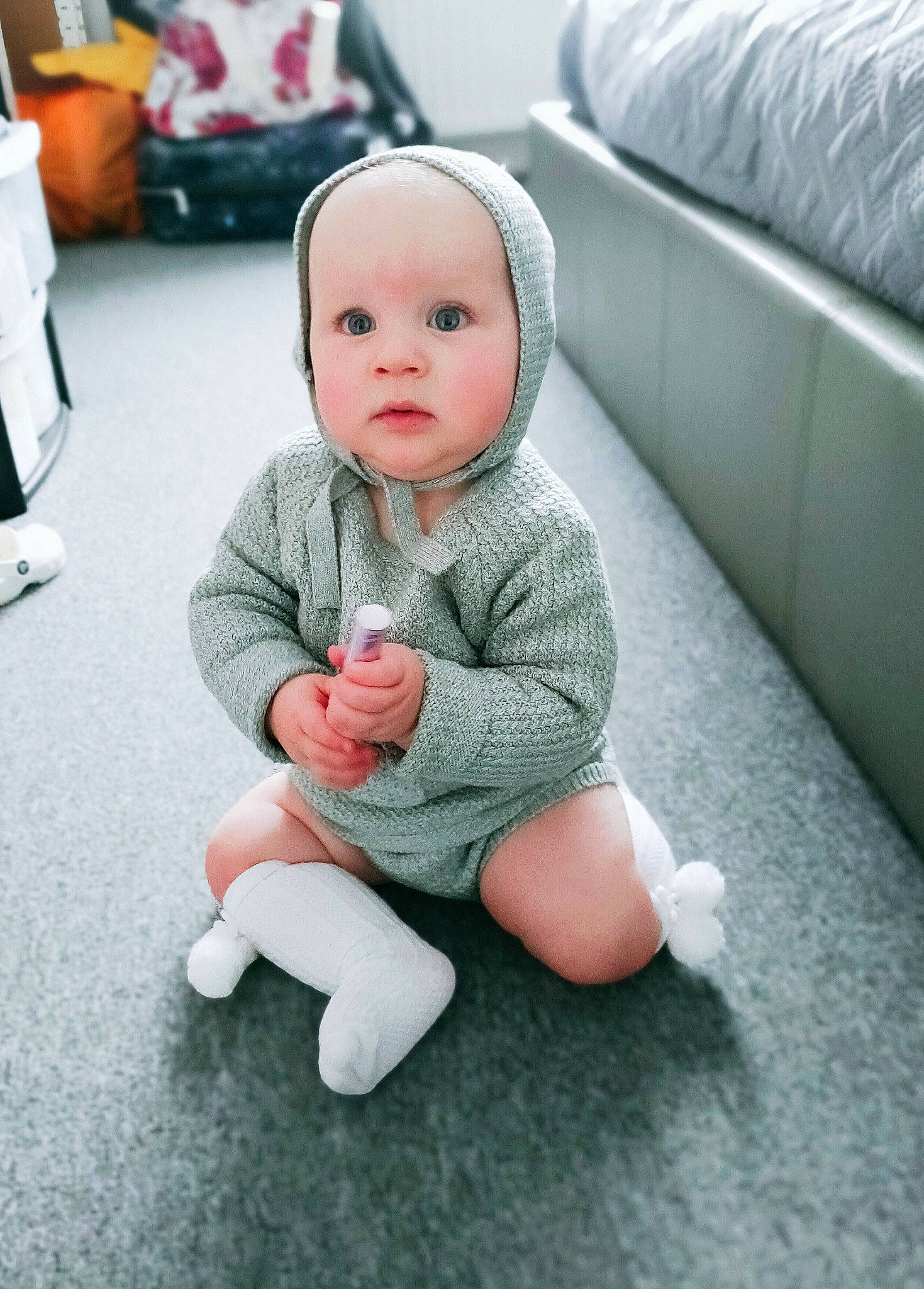 Kobe is registered to the contest to win money with this photo: baby, baby_toddler_clothing, cheek, child, comfort, dress, eye, finger, floor, flooring, foot, gesture, happy, human_leg, joint, knee, person, sitting, sleeve, t_shirt