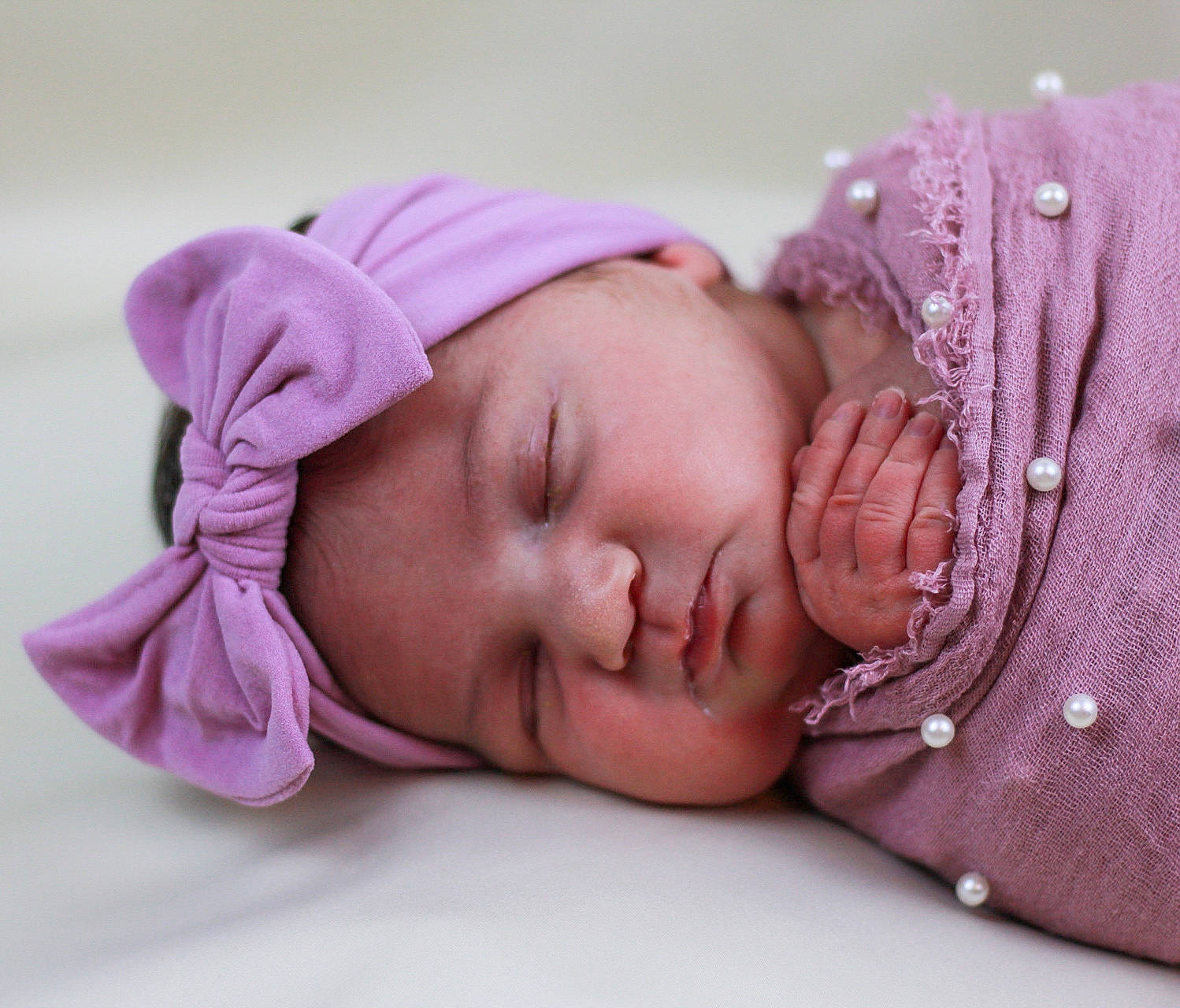 Raylee is registered to the contest to win money with this photo: arm, baby, baby_sleeping, baby_toddler_clothing, cap, cheek, child, comfort, eyelash, fashion_accessory, hair_accessory, hand, happy, headgear, headwear, knit_cap, lip, person, pink, skin