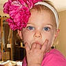 toddler, child, headband, flower, pink_clothing, indoor, portrait, blue_eyes, cute, baby, person, young_child, hand, face, hair, room, home, looking_at_camera, expression, casual