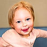 toddler, child, face, blue_eyes, blonde_hair, pink_sweater, tongue_out, smile, portrait, cute, indoors, person, baby, skin, cheeks, happy, young_child, closeup, head, expression
