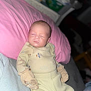 Carson joined the competition — help win amazing prizes! baby, sleeping, pajamas, mittens, pink_pillow, infant, face, cozy, indoors, blanket, resting, cute, child, newborn, soft_lighting, portrait, person, clothing, bed, peaceful