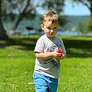 Tatum joined the competition — help win amazing prizes! child, boy, grass, outdoor, summer, popsicle, greenery, tree, nature, casual_clothing, shorts, tshirt, daylight, portrait, standing, sunlight, recreation, playful, happy, vacation