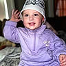 toddler, child, smiling, purple_outfit, bucket_hat, indoor, blanket, cute, happy, face, hand, eyes, clothing, portrait, baby, cozy, casual, sitting, playful, young_child