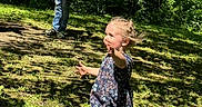 Aurora is registered to the contest to win money with this photo: child, toddler, running, outdoor, grass, sunlight, trees, adult, casual_clothing, shadows, nature, playful, dress, sneakers, joyful, summer, park, greenery, person, daylight