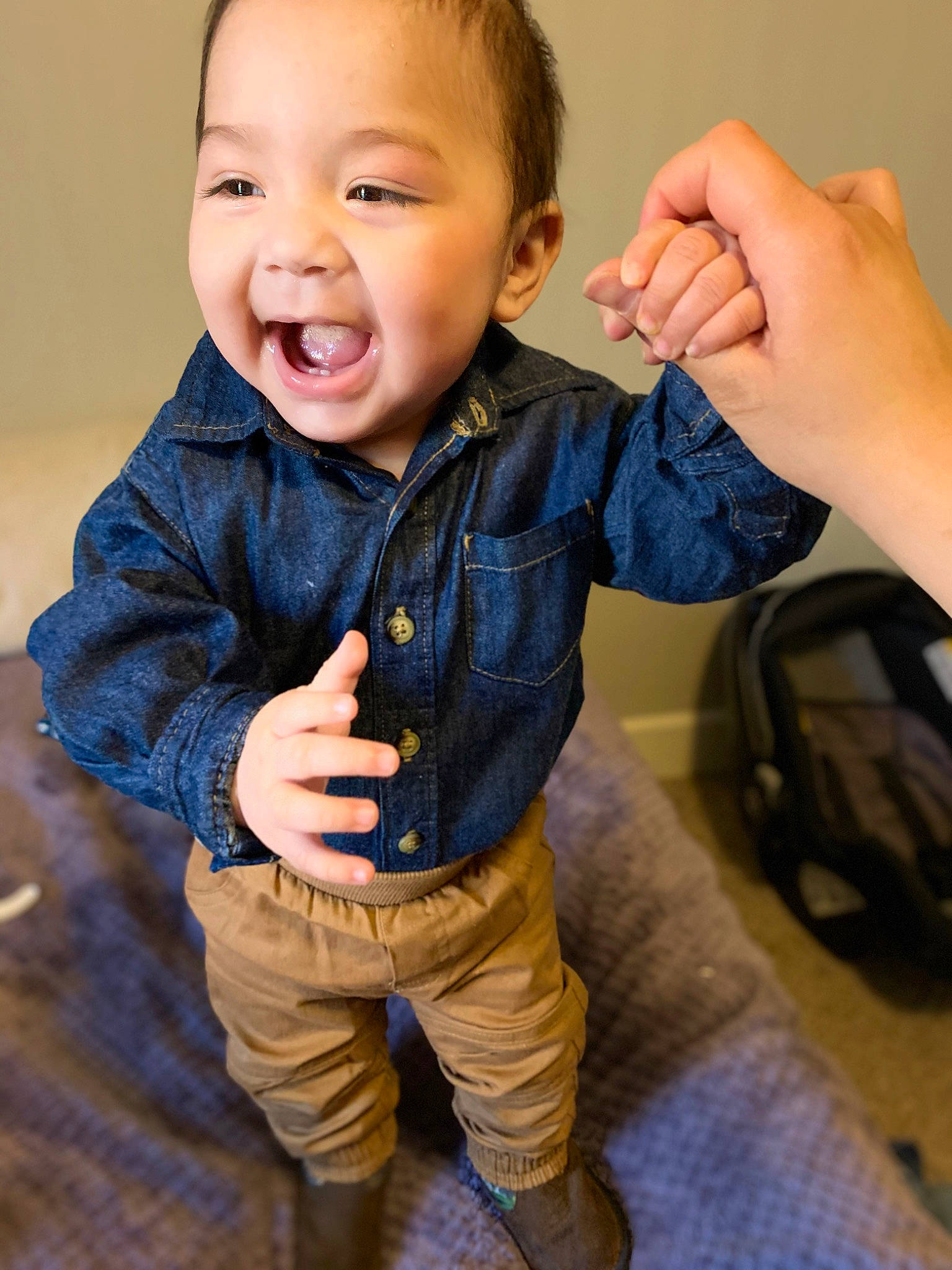 Zael is registered to the contest to win money with this photo: baby, blue, cheek, child, child_model, denim, facial_expression, finger, gesture, hand, jacket, jeans, joy, laugh, nose, outerwear, person, skin, smile, standing