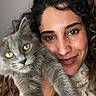 woman, cat, pet, portrait, smile, curly_hair, gray_cat, indoor, face, fur, eyes, closeup, friendship, happy, cute, animal, human, love, domestic, affection
