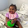 Kyomi joined the competition — help win amazing prizes! baby, child, smiling, laughing, green_ball, bed, pigtails, pink_bib, purple_clothing, barefoot, indoor, happy, cute, person, infant, playful, toy, skin, hand, foot