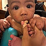 baby, child, hand, finger, teething, closeup, face, indoor, skin, foot, curious, nibble, person, infant, young_child, expression, mouth, baby_seat, human, interaction