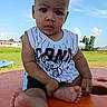 baby, child, outdoor, grass, sky, tree, table, foot, shirt, sleeveless, curious, portrait, person, greenery, sunlight, casual, summer, expression, candid, cute