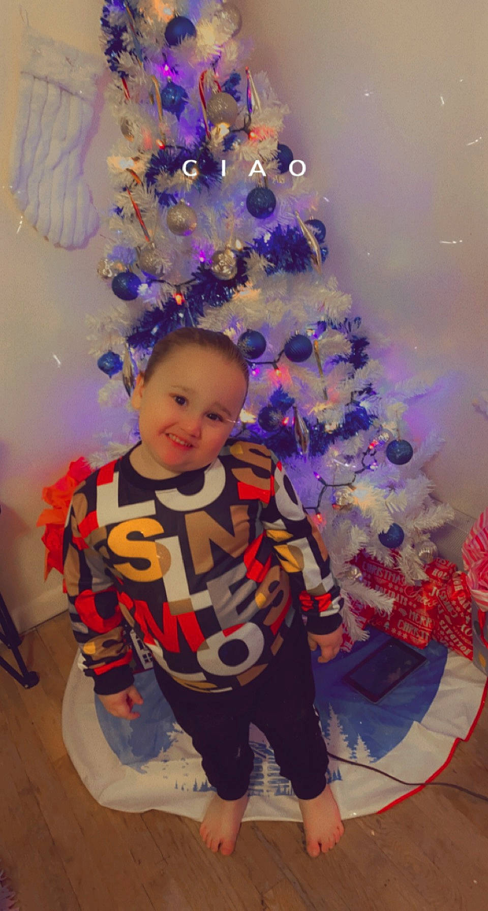 Kayden is registered to the contest to win money with this photo: christmas, christmas_decoration, christmas_eve, christmas_ornament, christmas_tree, electric_blue, event, fun, happy, holiday, holiday_ornament, interior_design, joy, magenta, ornament, person, plant, purple, room, toddler