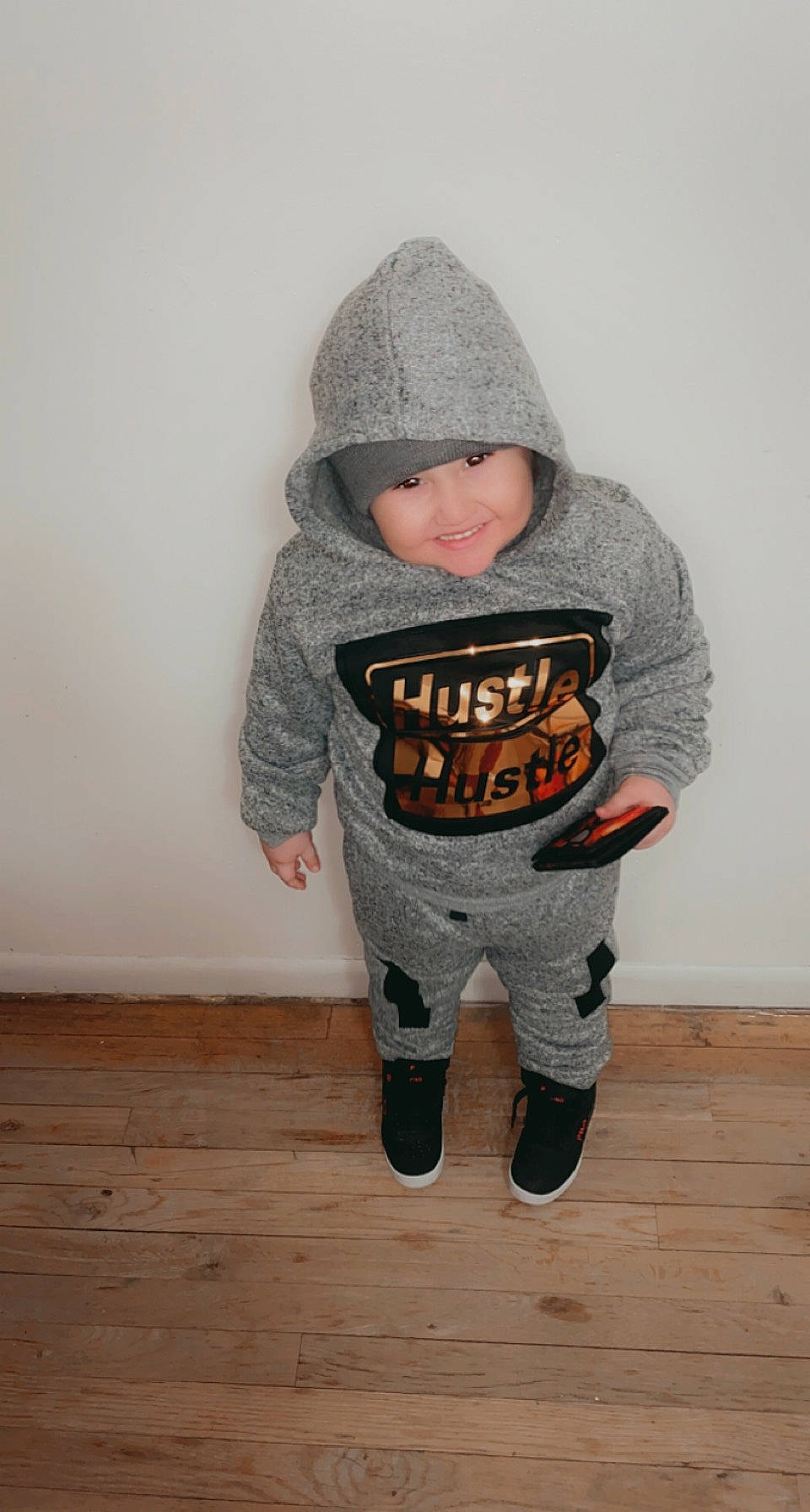 Kayden joined the competition — help win amazing prizes! baby, baby_toddler_clothing, cap, child, flooring, fur, grey, hardwood, headwear, hood, human_body, jacket, joy, knee, outerwear, pattern, person, personal_protective_equipment, sleeve, t_shirt