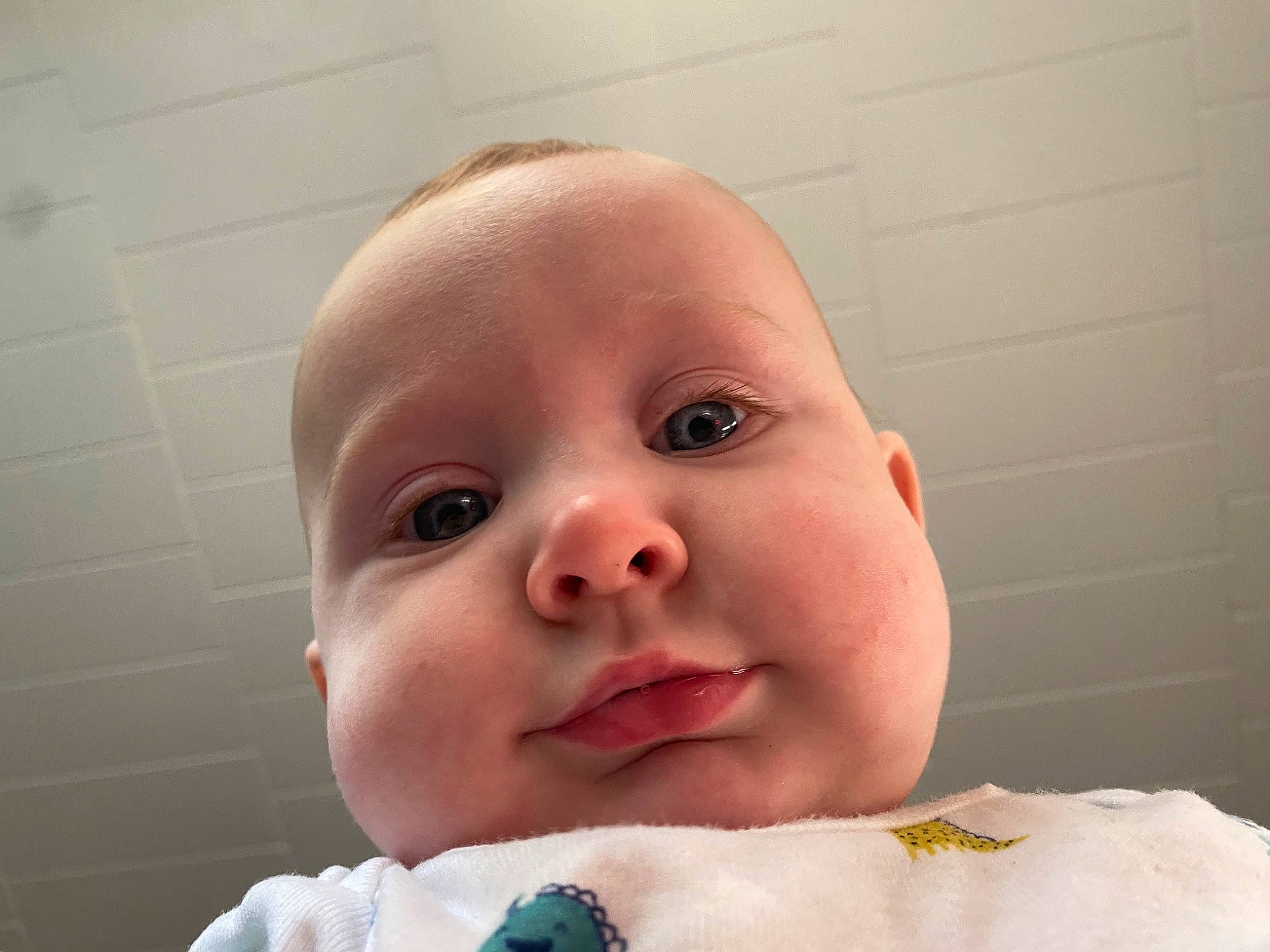 Isaiah is registered to the contest to win money with this photo: baby, baby_toddler_clothing, bathing, cheek, comfort, eyebrow, eyelash, finger, gesture, happy, head, iris, linens, lip, mouth, nail, nose, person, smile, thumb