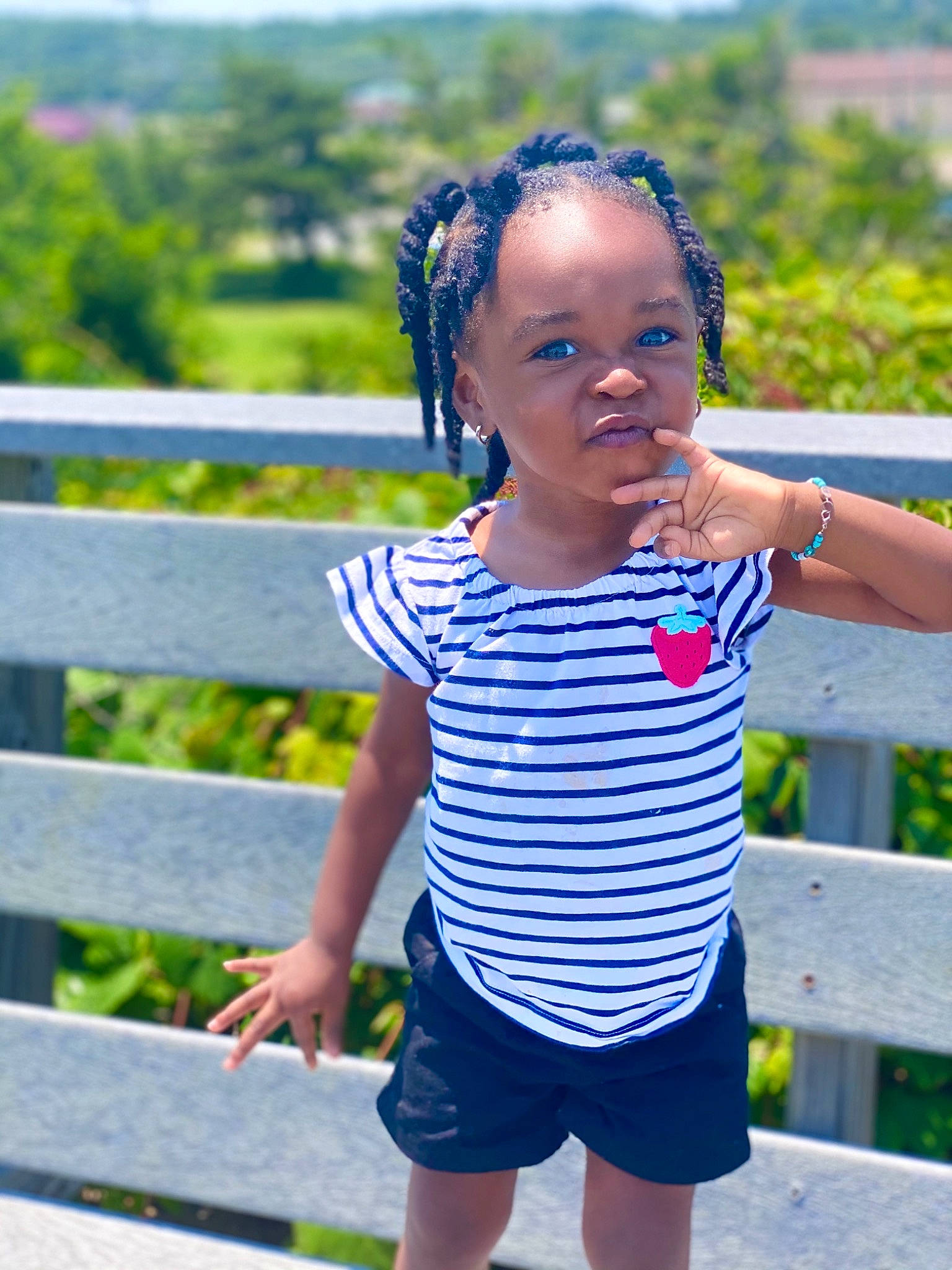 Jori is registered to the contest to win money with this photo: azure, baby_toddler_clothing, child, cool, fence, fun, grass, happy, leisure, people_in_nature, person, plant, shoulder, sleeve, standing, street_fashion, summer, sunlight, toddler, tree