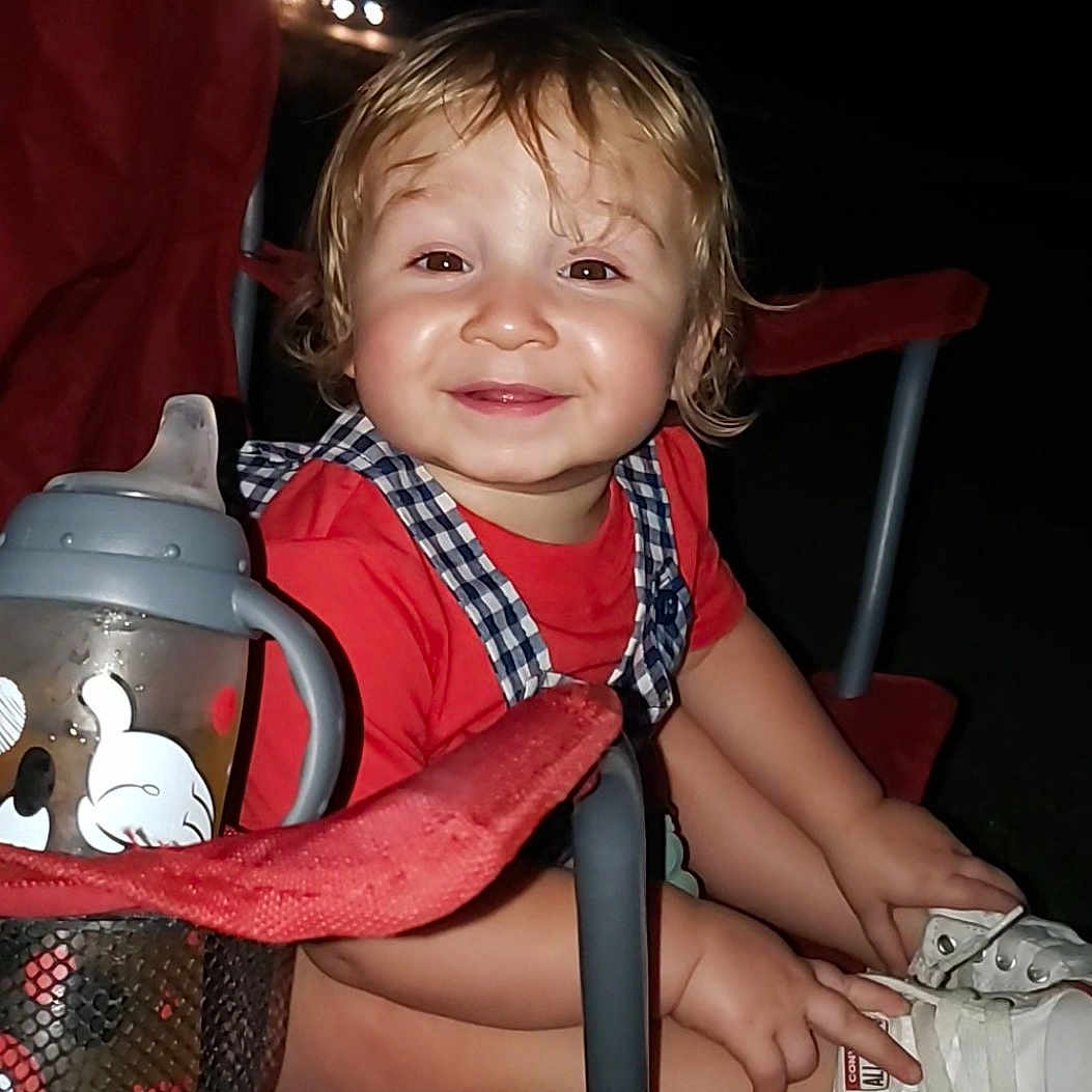 Kayce is registered to the contest to win money with this photo: baby, ball, clothing, face, football, footwear, furniture, head, outdoors, person, photography, portrait, pottery, shoe, shorts, sitting, sneaker, soccer, soccerball, sport