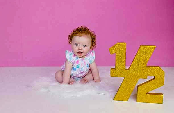 Braelee joined the competition — help win amazing prizes! baby, baby_toddler_clothing, child, circle, crawling, finger, flash_photography, flooring, fun, happy, magenta, person, pink, purple, room, sitting, sleeve, smile, t_shirt, toddler