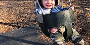 Joseph is registered to the contest to win money with this photo: baby, clothing, face, footwear, grass, head, hosiery, nature, outdoorplayarea, outdoors, pants, park, person, photography, plant, playarea, portrait, shoe, sock, vegetation