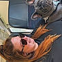 woman, dog, french_bulldog, sunglasses, bus, seat, pet, travel, portrait, casual, leisure, red_hair, earrings, black_clothing, animal, companion, indoor, resting, cute, friendly