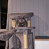 cat, cat_tree, gray_cat, indoor, pet, furniture, scratching_post, relaxed, animal, feline, home, cozy, sitting, looking, ears, whiskers, living_room, shadow, wood_paneling, table